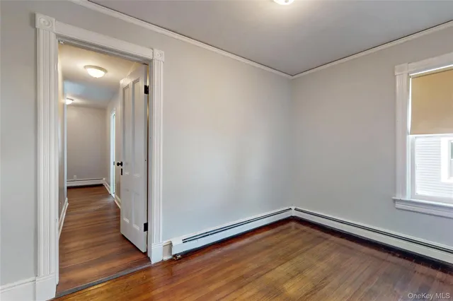 a view of a hallway with wooden floor and entryway