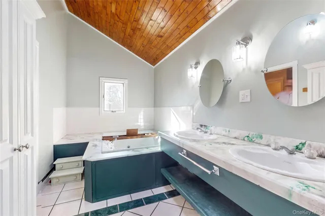 a bathroom with a sink a mirror and a shower