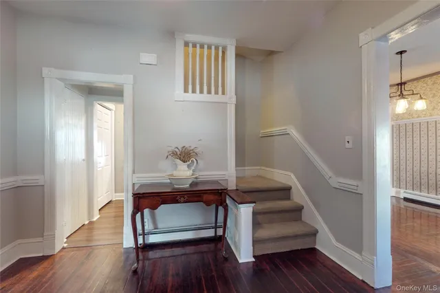 a view of entryway with wooden floor and stairs