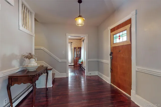a view of a livingroom with wooden floor and a window