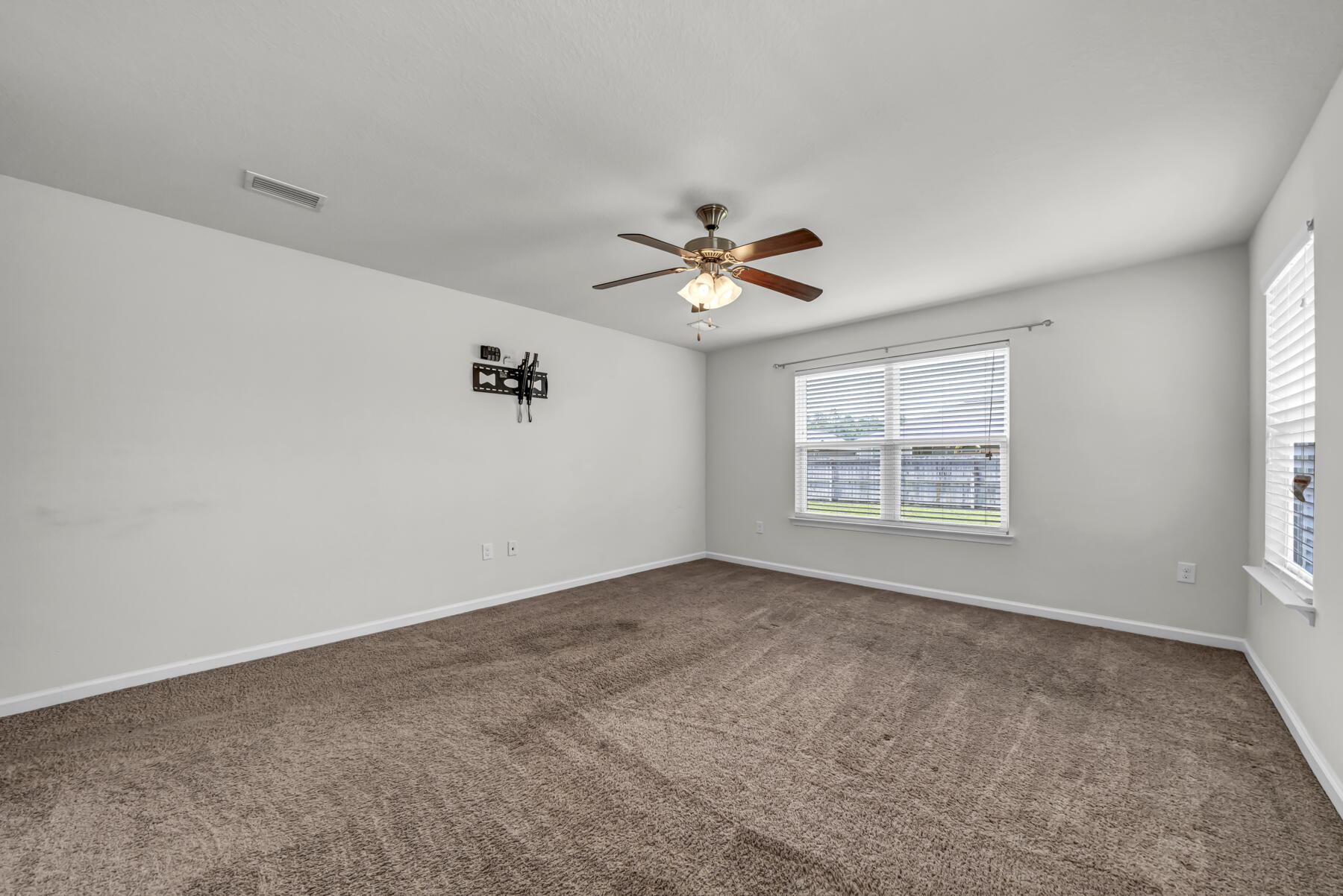 3005 Raven Lane Crestview, FL 32539 - Photo 11 of 24 an empty room with windows and ceiling fan