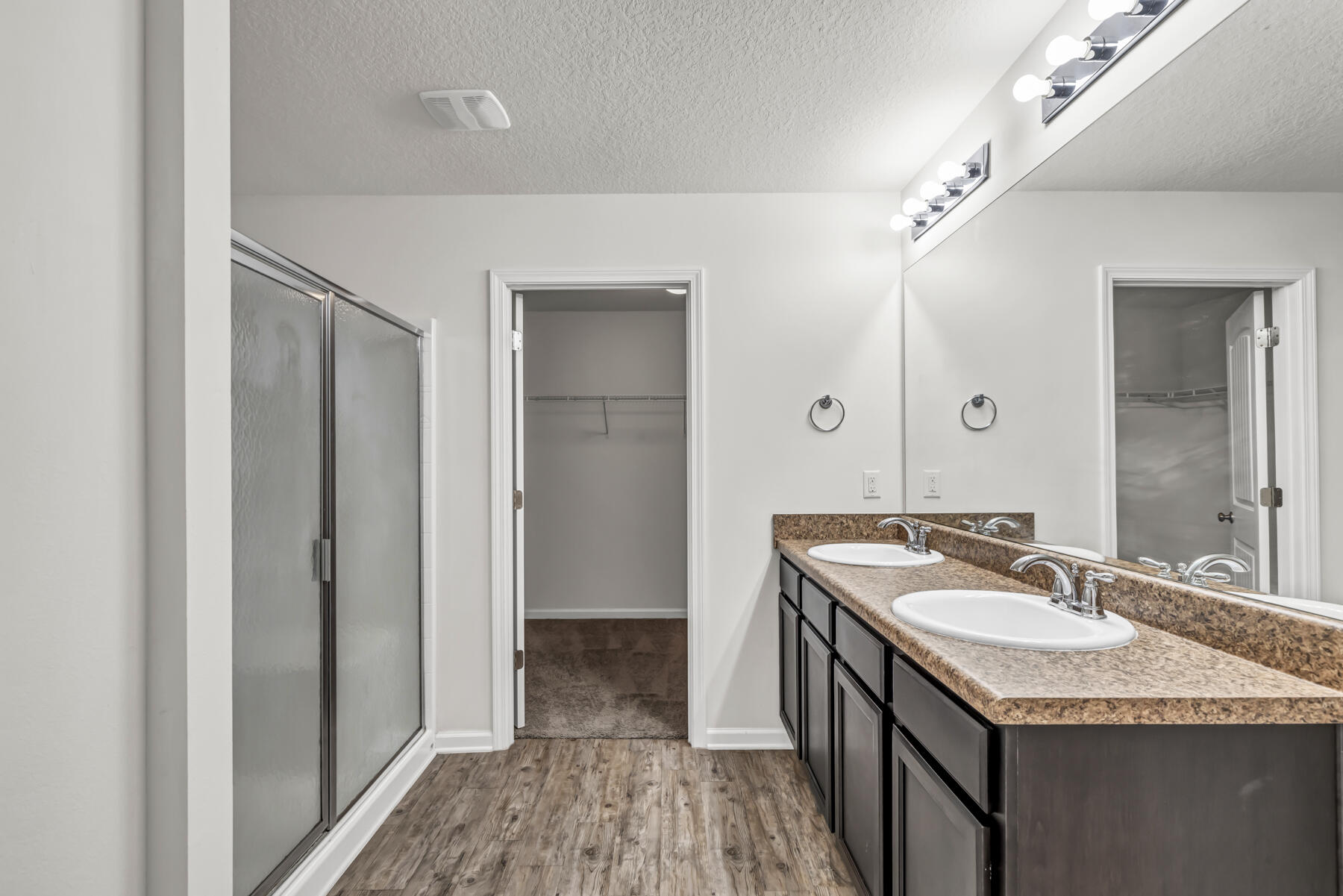 3005 Raven Lane Crestview, FL 32539 - Photo 14 of 24 a bathroom with a granite countertop sink a mirror and shower