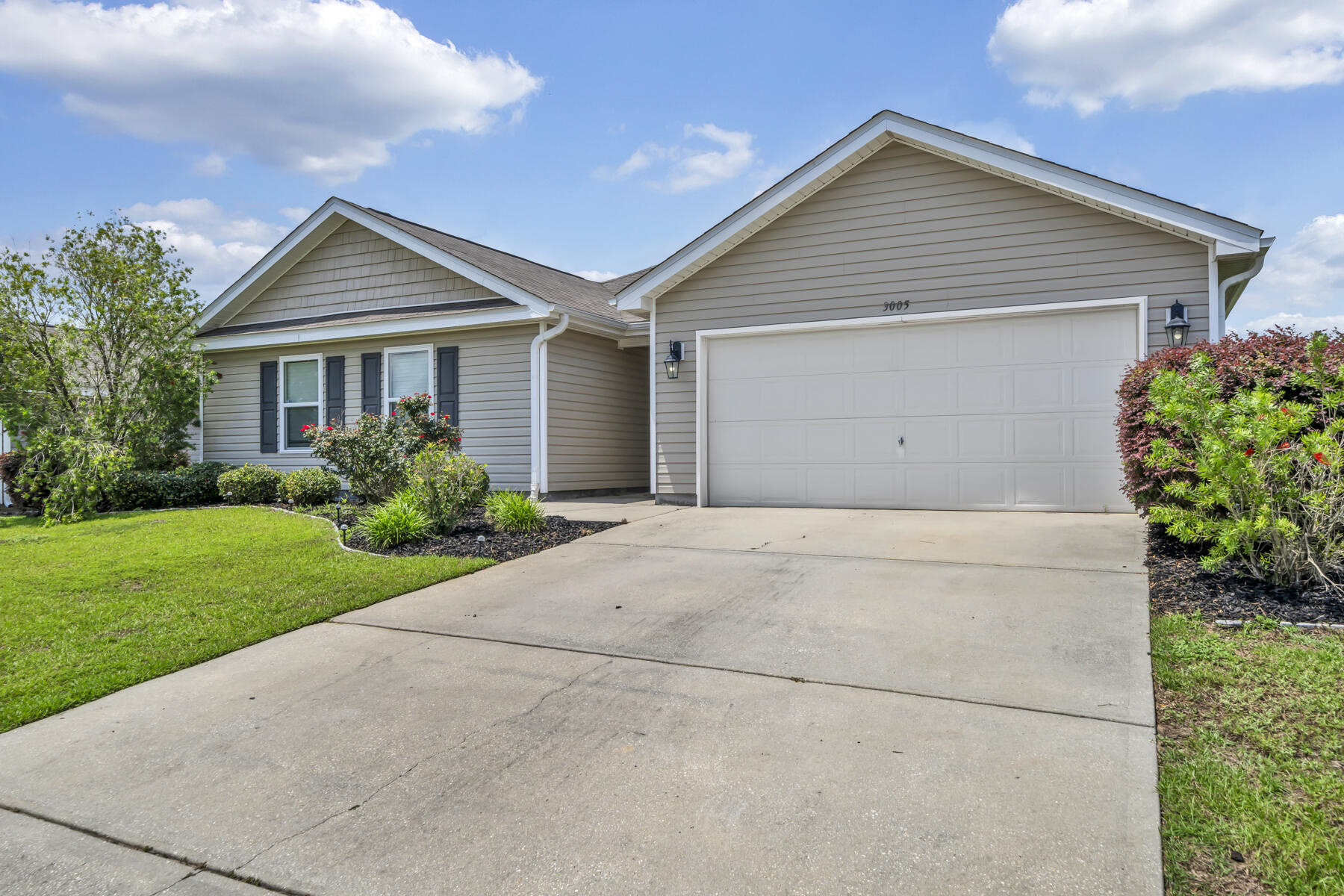 3005 Raven Lane Crestview, FL 32539 - Photo 2 of 24 a view of a house with a yard and plants