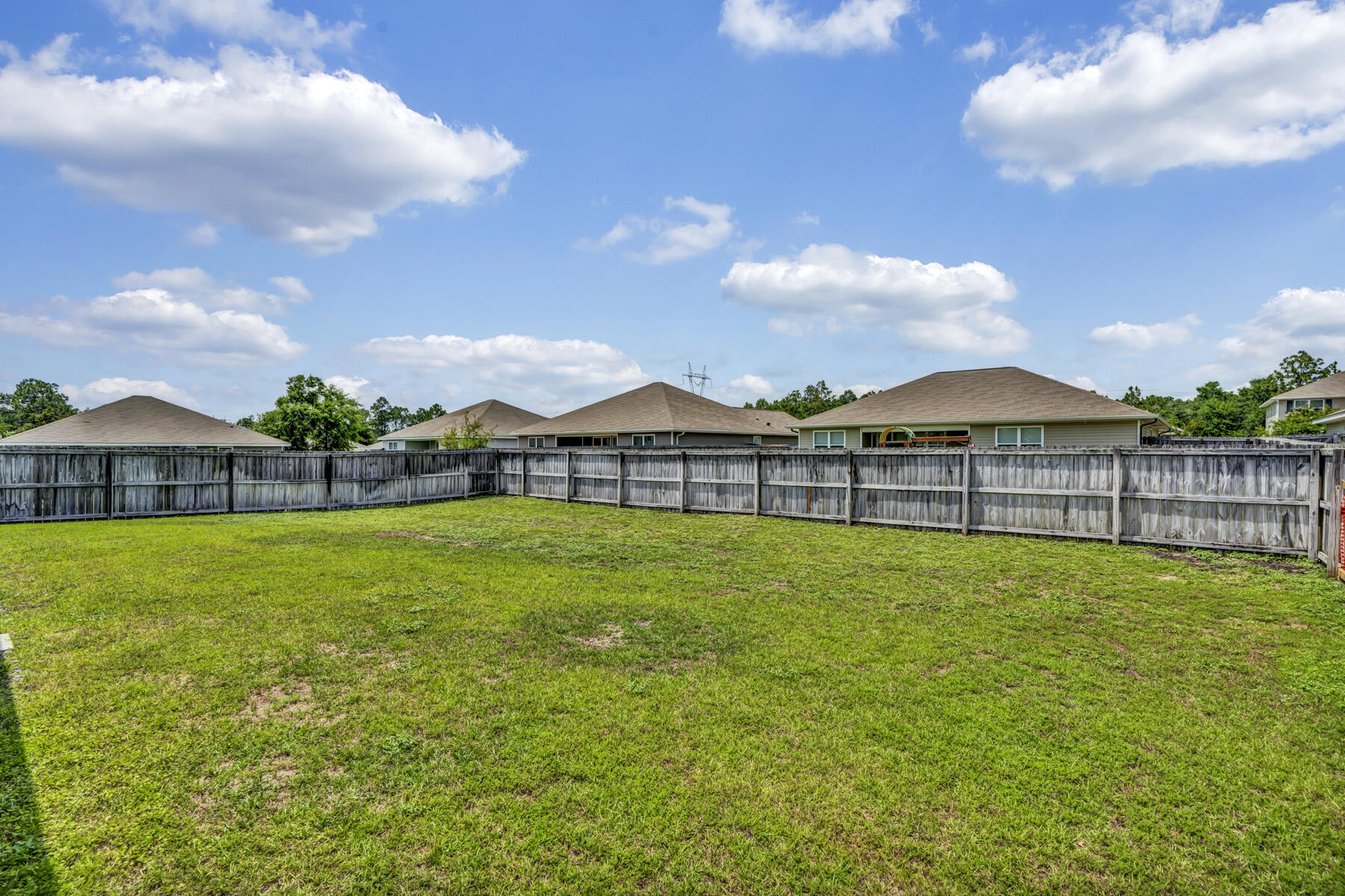 3005 Raven Lane Crestview, FL 32539 - Photo 22 of 24 a view of a house with a big yard and a large tree