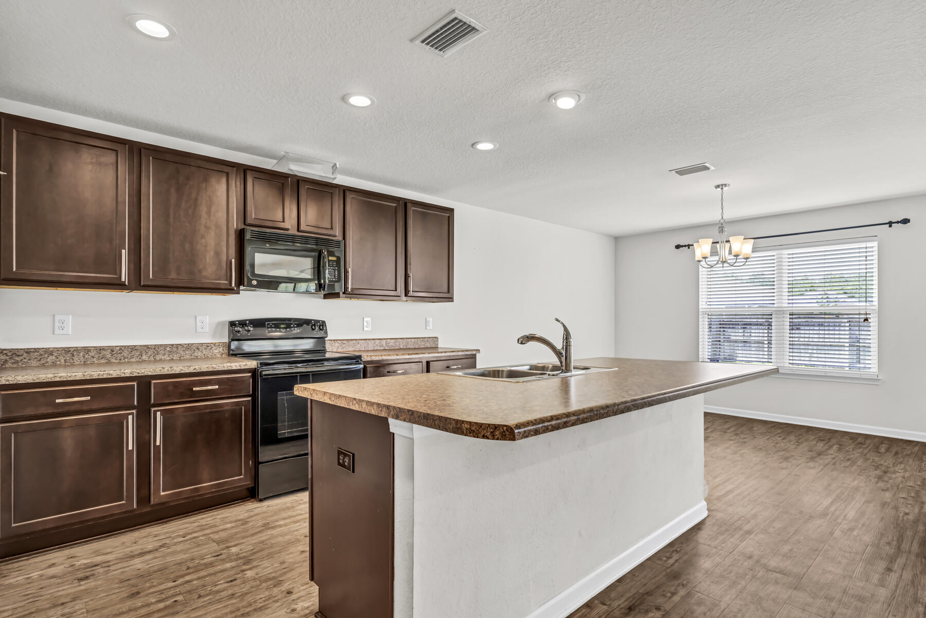 3005 Raven Lane Crestview, FL 32539 - Photo 4 of 24 a kitchen with stainless steel appliances granite countertop a sink stove and refrigerator