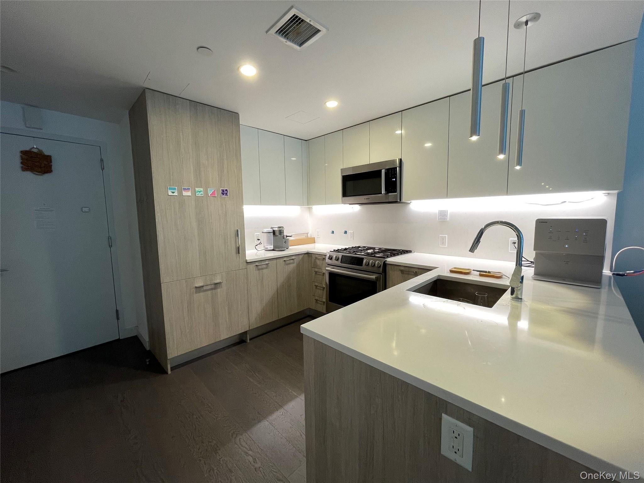 131-05 40 Road, Unit 15M Queens, NY 11354 - Photo 11 of 14 a kitchen with refrigerator and sink