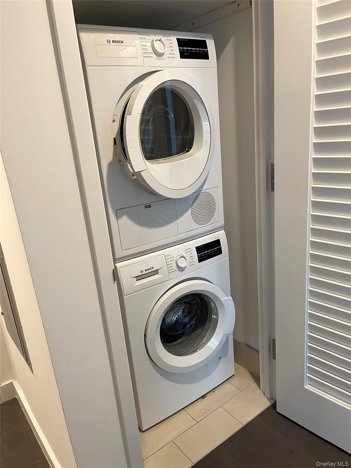 131-05 40 Road, Unit 15M Queens, NY 11354 - Photo 3 of 14 a utility room with dryer and washer