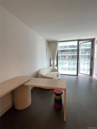 a kitchen with refrigerator and chairs