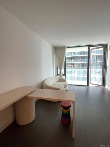 a kitchen with refrigerator and chairs
