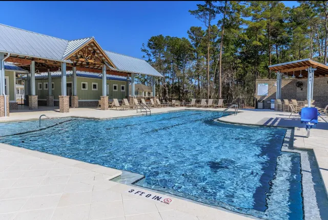 a view of a house with backyard porch and sitting area