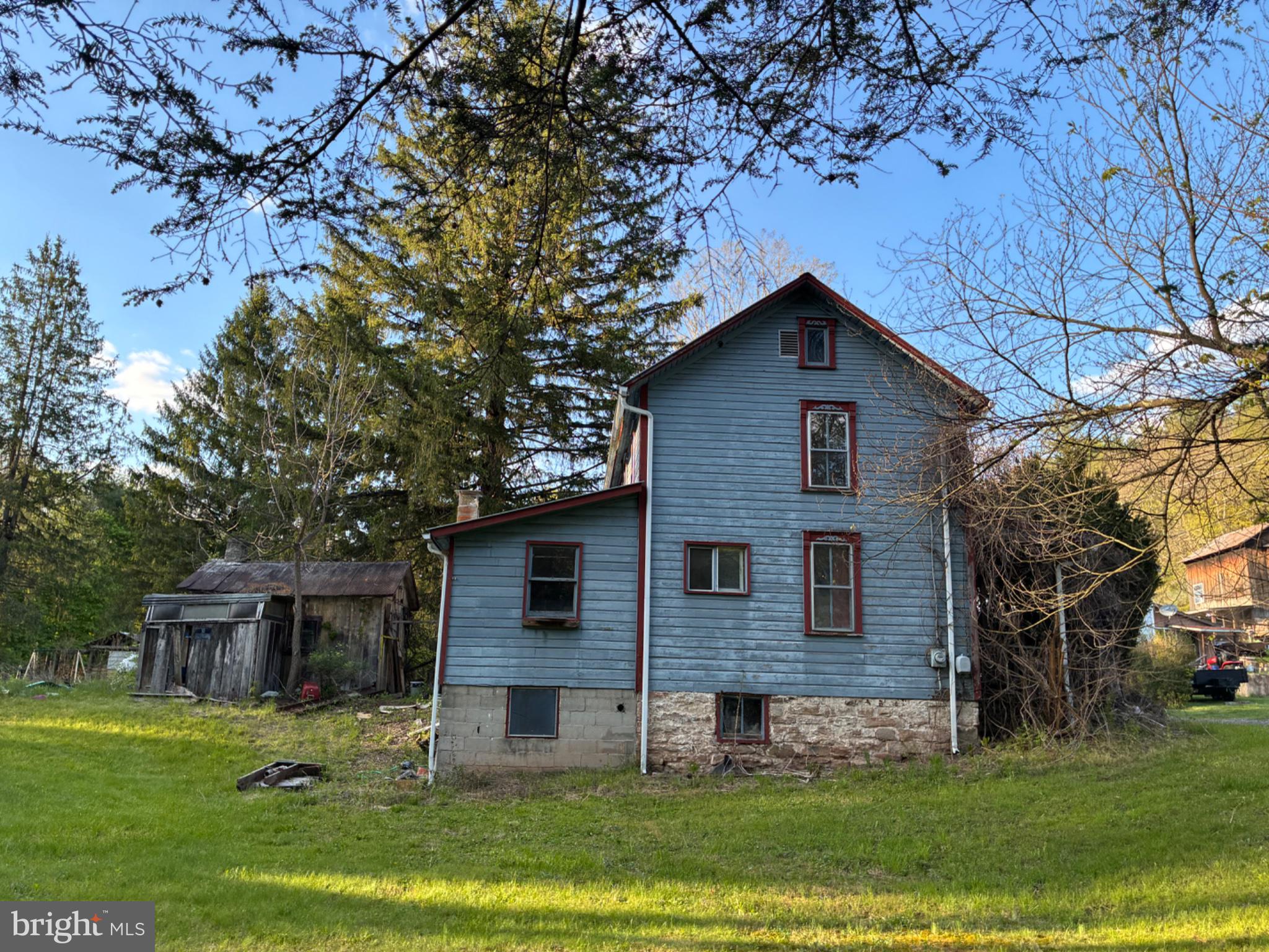 201 Hoover Road Robertsdale, PA 16674 - Photo 47 of 55 Charming blue home amidst nature's embrace.