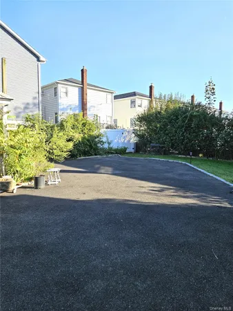 a view of a house with a yard and potted plants