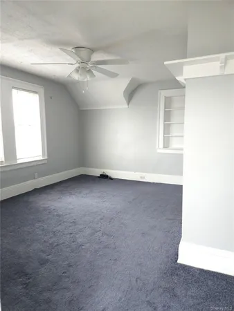an empty room with a empty space and windows