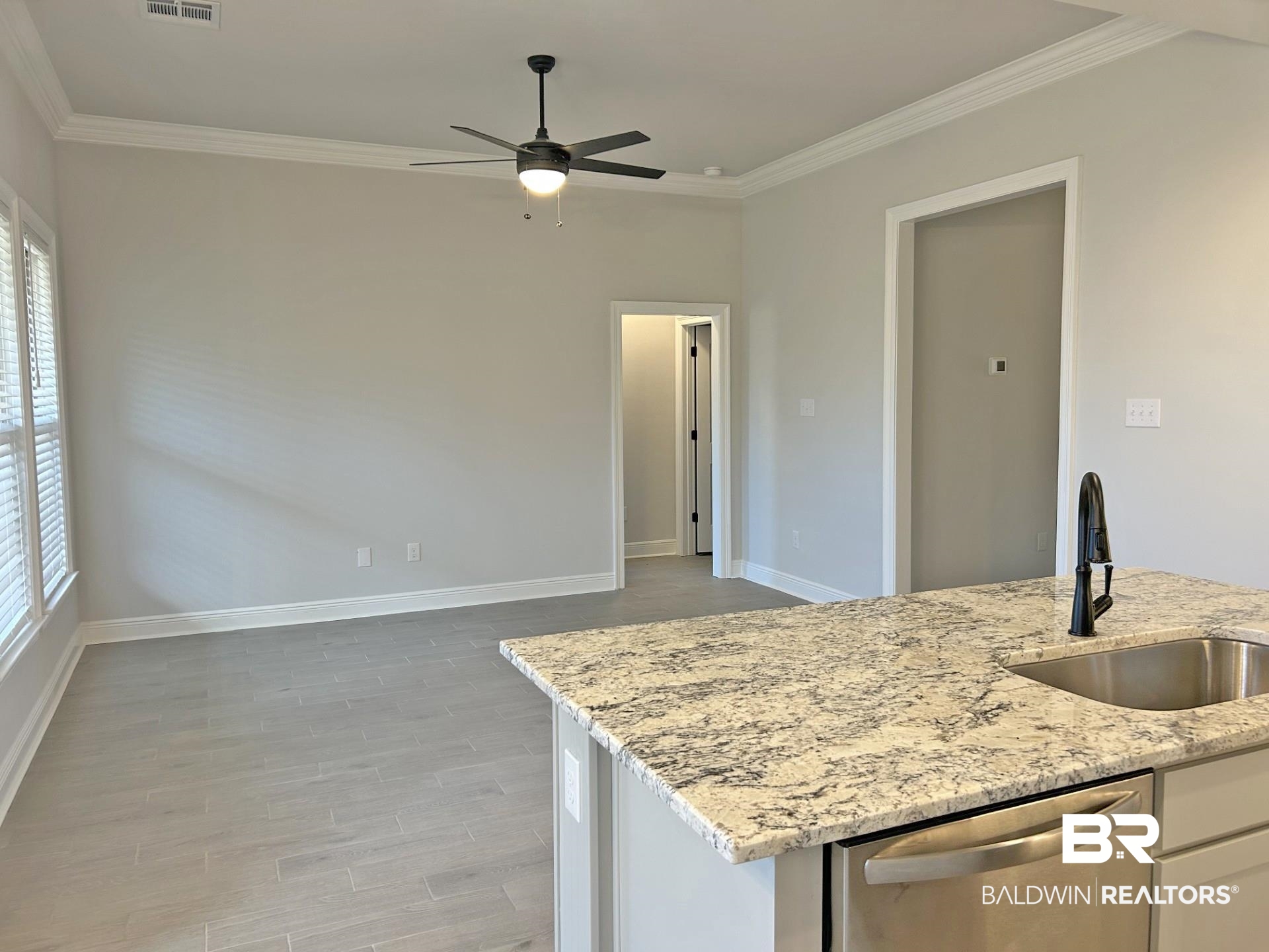 1748 Breckinridge Place Foley, AL 36535 - Photo 5 of 25 Kitchen featuring dishwasher, light stone counters, wood finish floors, a ceiling fan, and ornamental molding