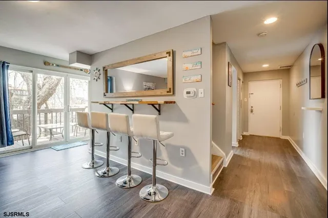 a view of a livingroom with furniture wooden floor and windows