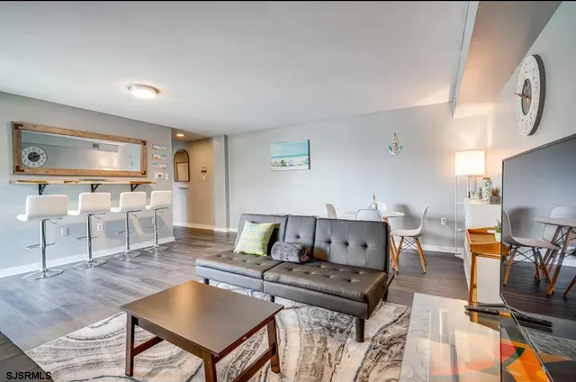 a living room with furniture a table and chairs