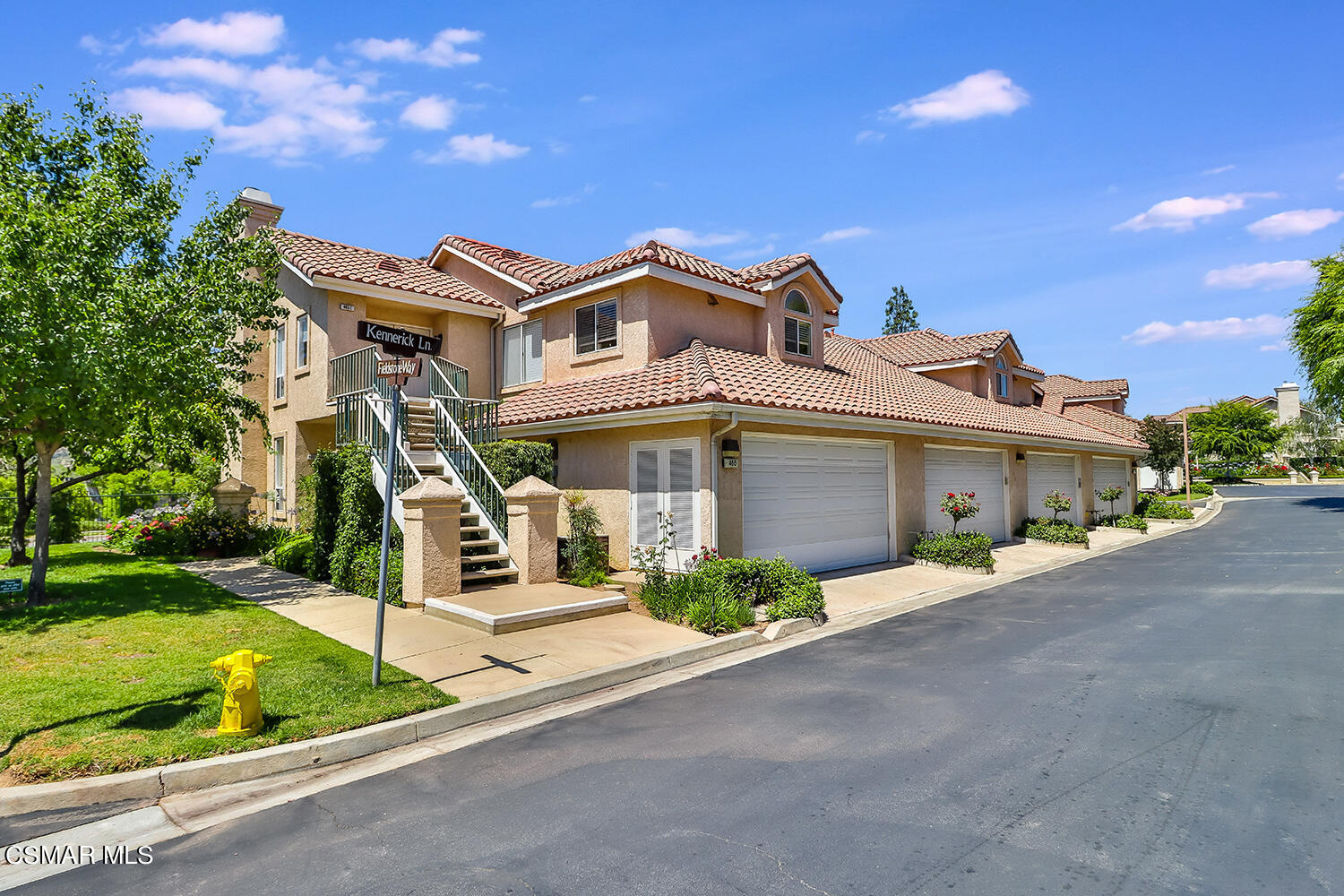 465 Kennerick Lane, Unit D Simi Valley, CA 93065 - Photo 1 of 1 a front view of a house with a garden and plants