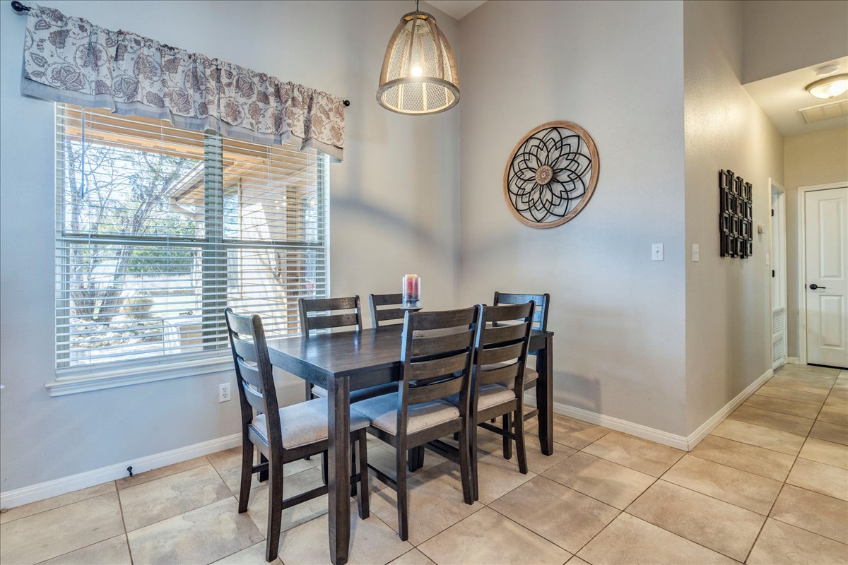 11 Rhapsody Lane Wimberley, TX 78676 - Photo 10 of 35 a view of a dining room with furniture and a window