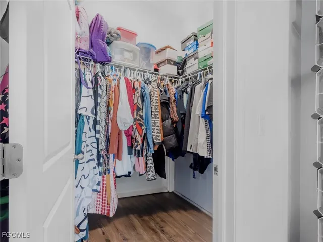 a view of walk in closet with clothes