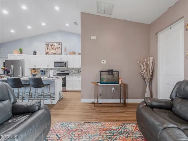 a living room with furniture and a wooden floor
