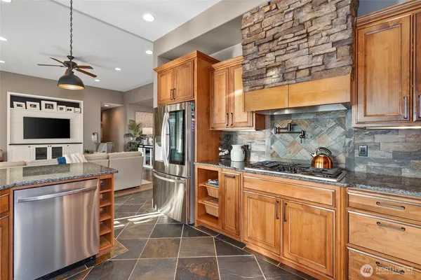 a kitchen with stainless steel appliances a refrigerator sink and cabinets