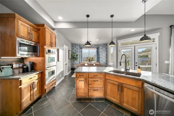 a kitchen with stainless steel appliances a sink stove and refrigerator
