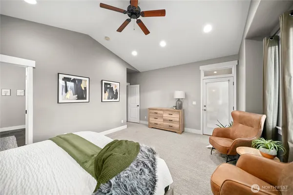 a spacious bathroom with a granite countertop sink a toilet a mirror and shower