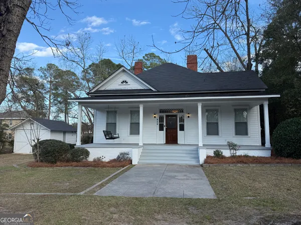 a front view of a house with garden