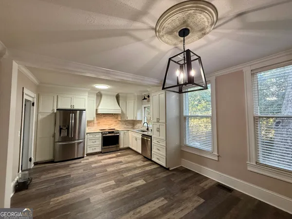 a view of an empty room with a fireplace and a window
