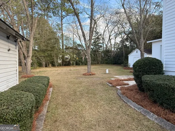 a house that has a tree in front of it