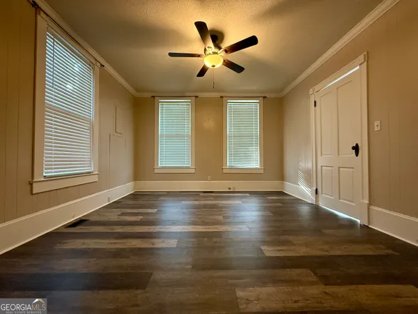 a view of a hallway with wooden floor and a fireplace