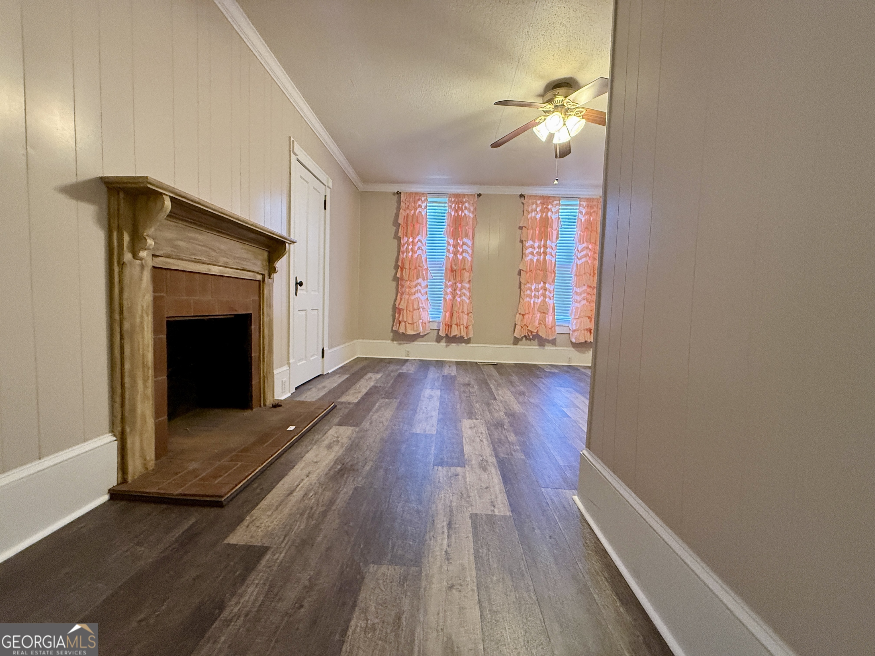 646 McLendon Street Ashburn, GA 31714 - Photo 37 of 63 a view of a hallway with wooden floor and a fireplace