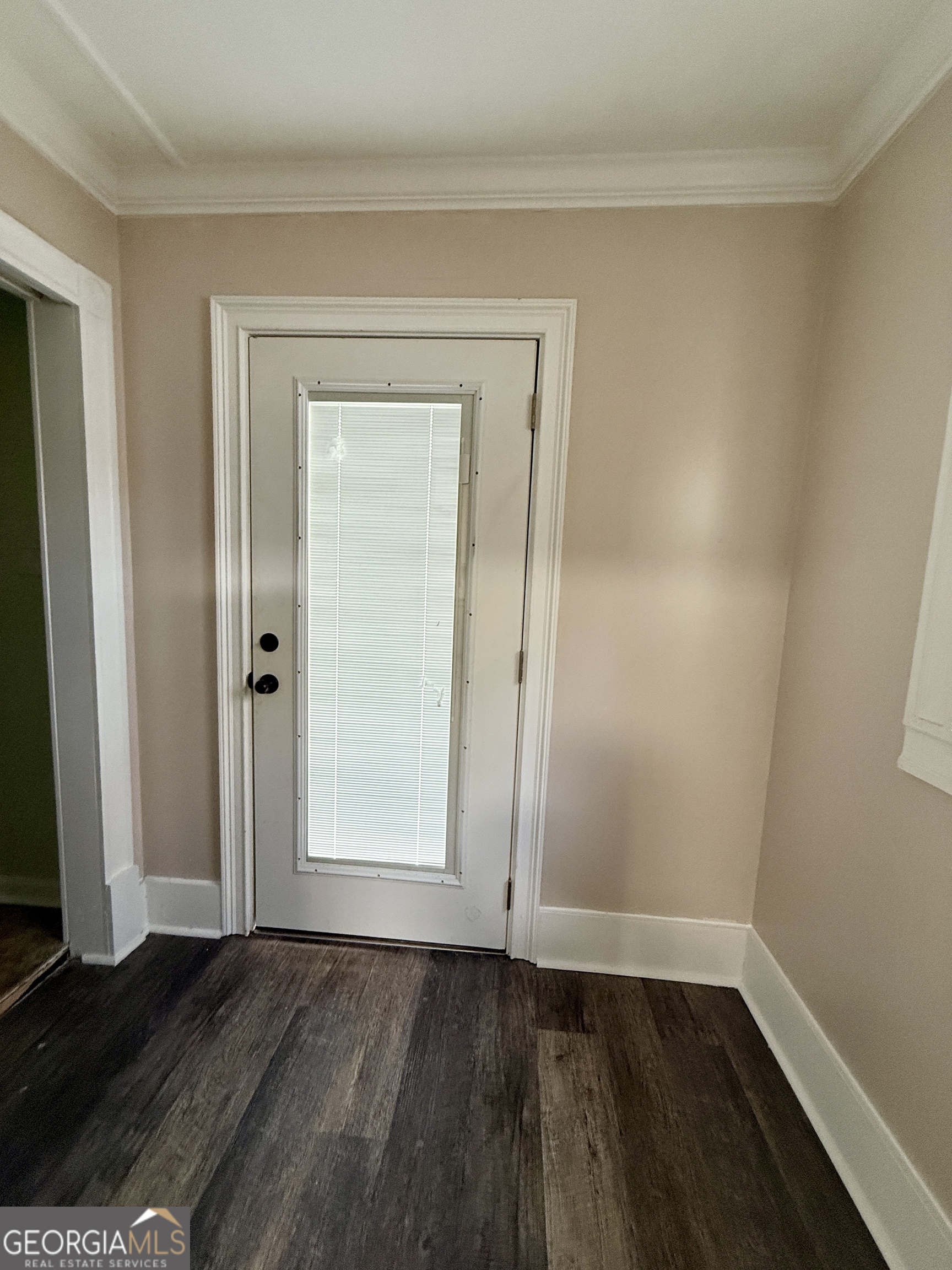 646 McLendon Street Ashburn, GA 31714 - Photo 46 of 63 a view of an empty room with wooden floor and a window