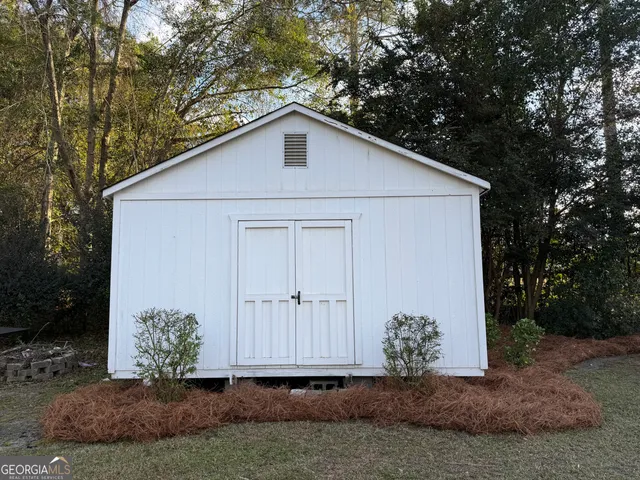 a view of wooden door and a window
