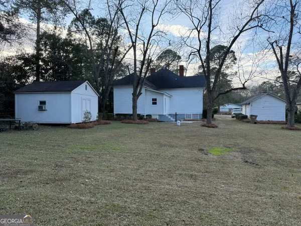 a house that has a tree in front of it