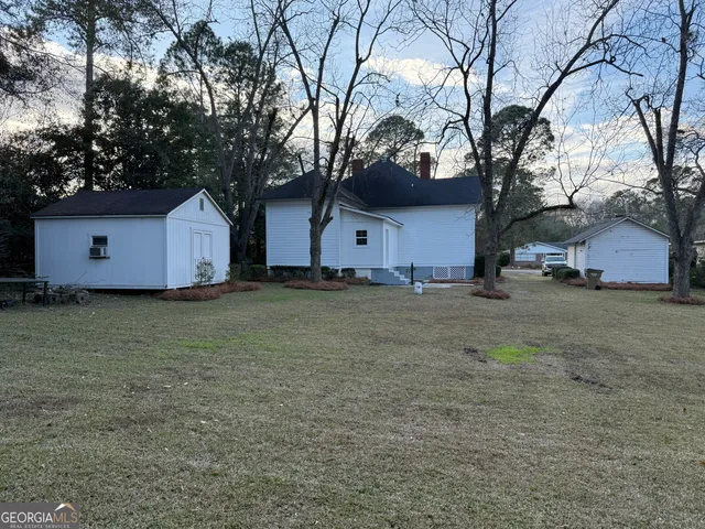 a house that has a tree in front of it