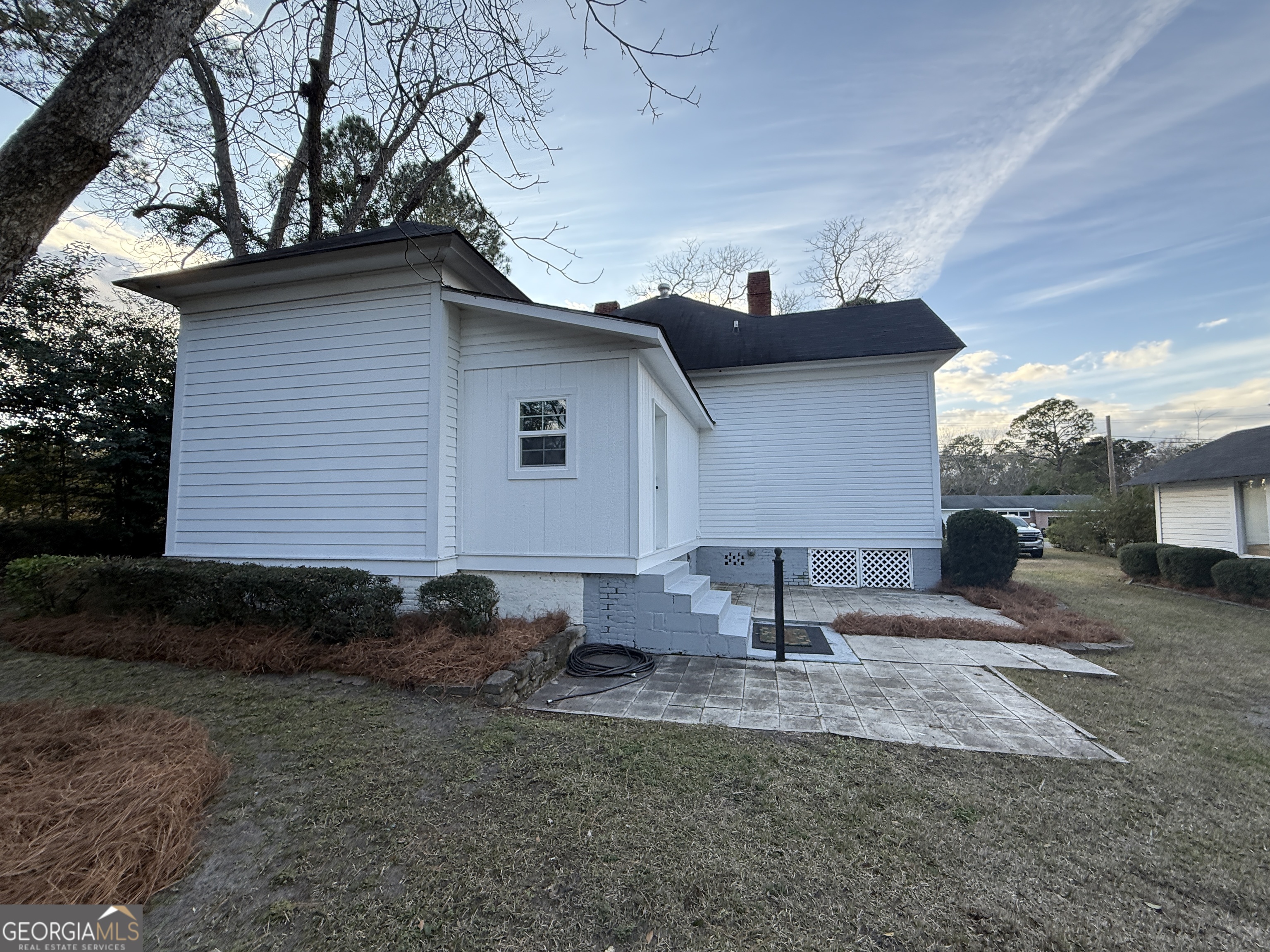 646 McLendon Street Ashburn, GA 31714 - Photo 54 of 63 a backyard of a house with lots of plants and trees