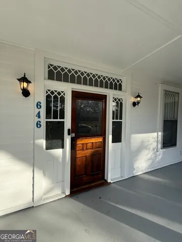 a view of a livingroom with wooden floor and a fireplace