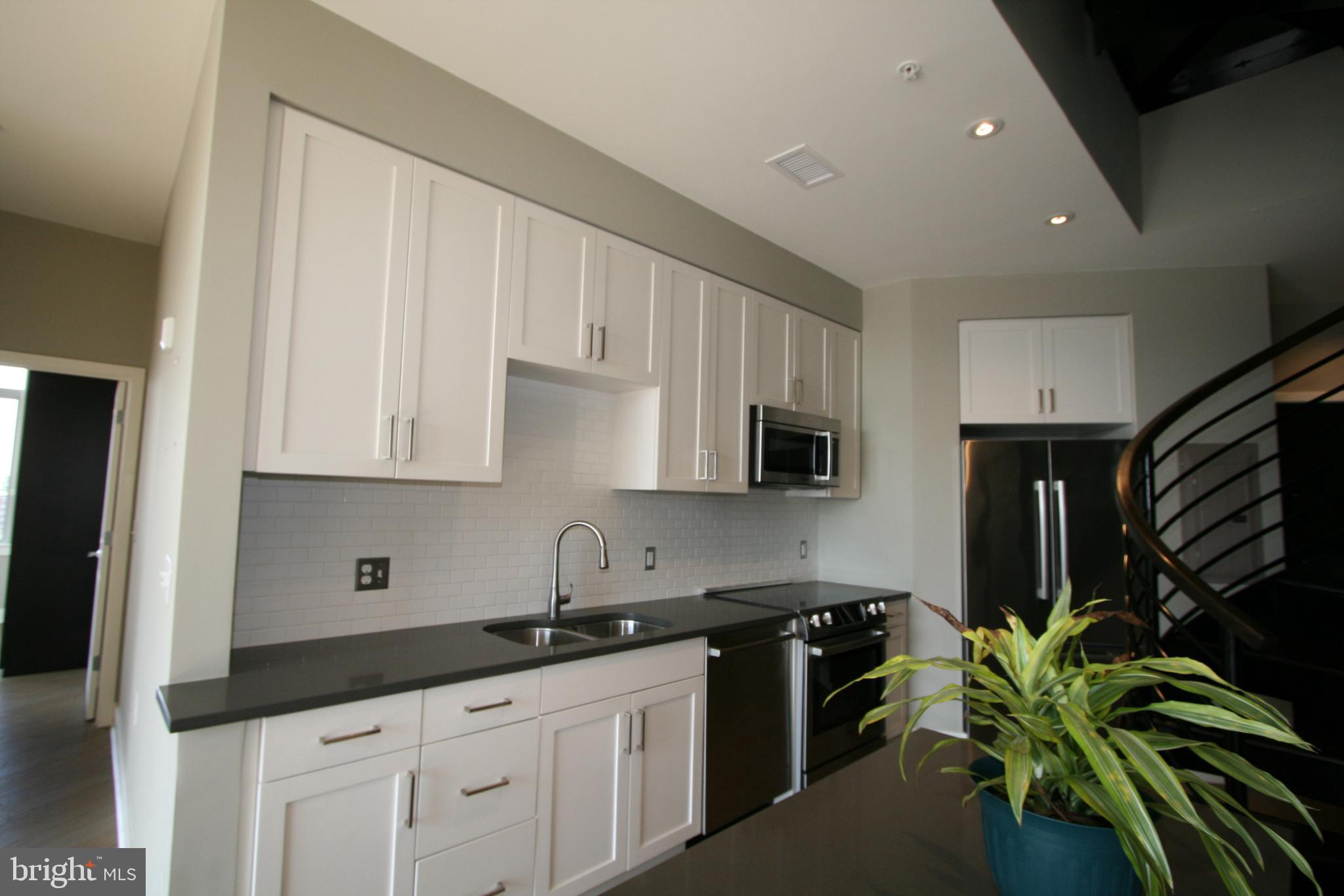 2550 17th Street Northwest, Unit 612 Washington, DC 20009 - Photo 8 of 55 a kitchen with stainless steel appliances a sink stove and cabinets