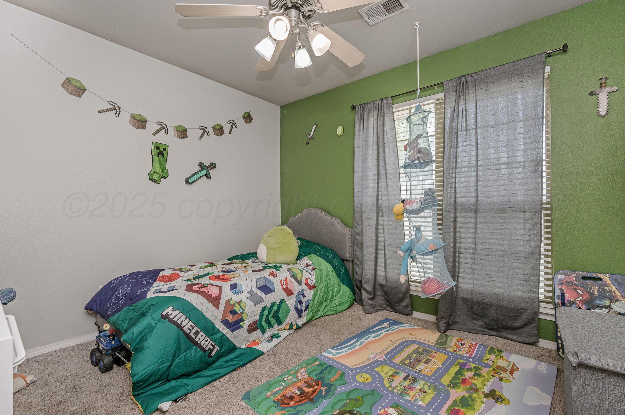 2002 Southwest 61st Avenue Amarillo, TX 79118 - Photo 12 of 21 a bedroom with a bed and a chandelier