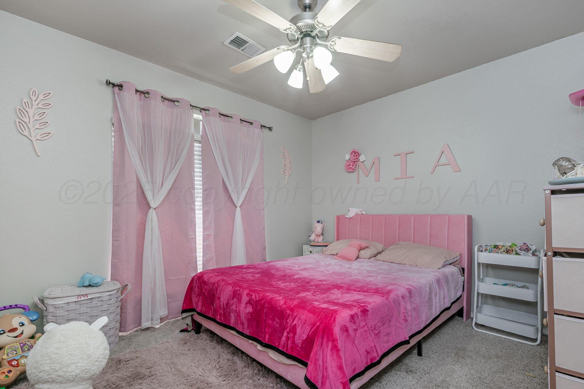 2002 Southwest 61st Avenue Amarillo, TX 79118 - Photo 13 of 21 a bedroom with a bed and a chandelier