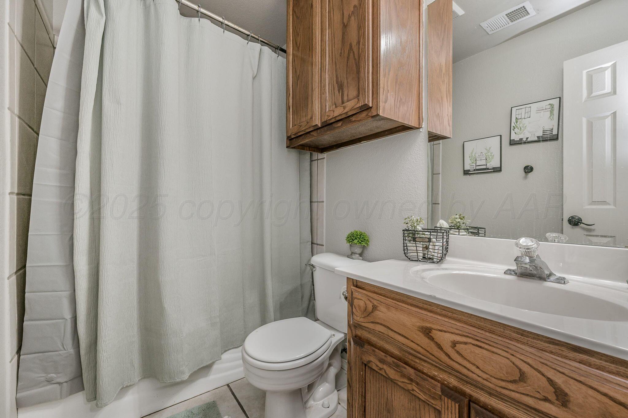 2002 Southwest 61st Avenue Amarillo, TX 79118 - Photo 14 of 21 a bathroom with a granite countertop sink and a toilet