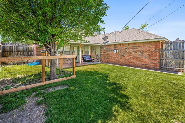 a front view of a house with a yard and porch