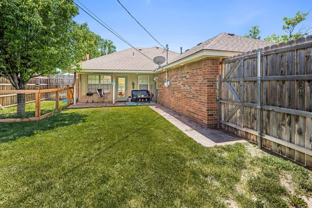 a view of a house with a yard and sitting area