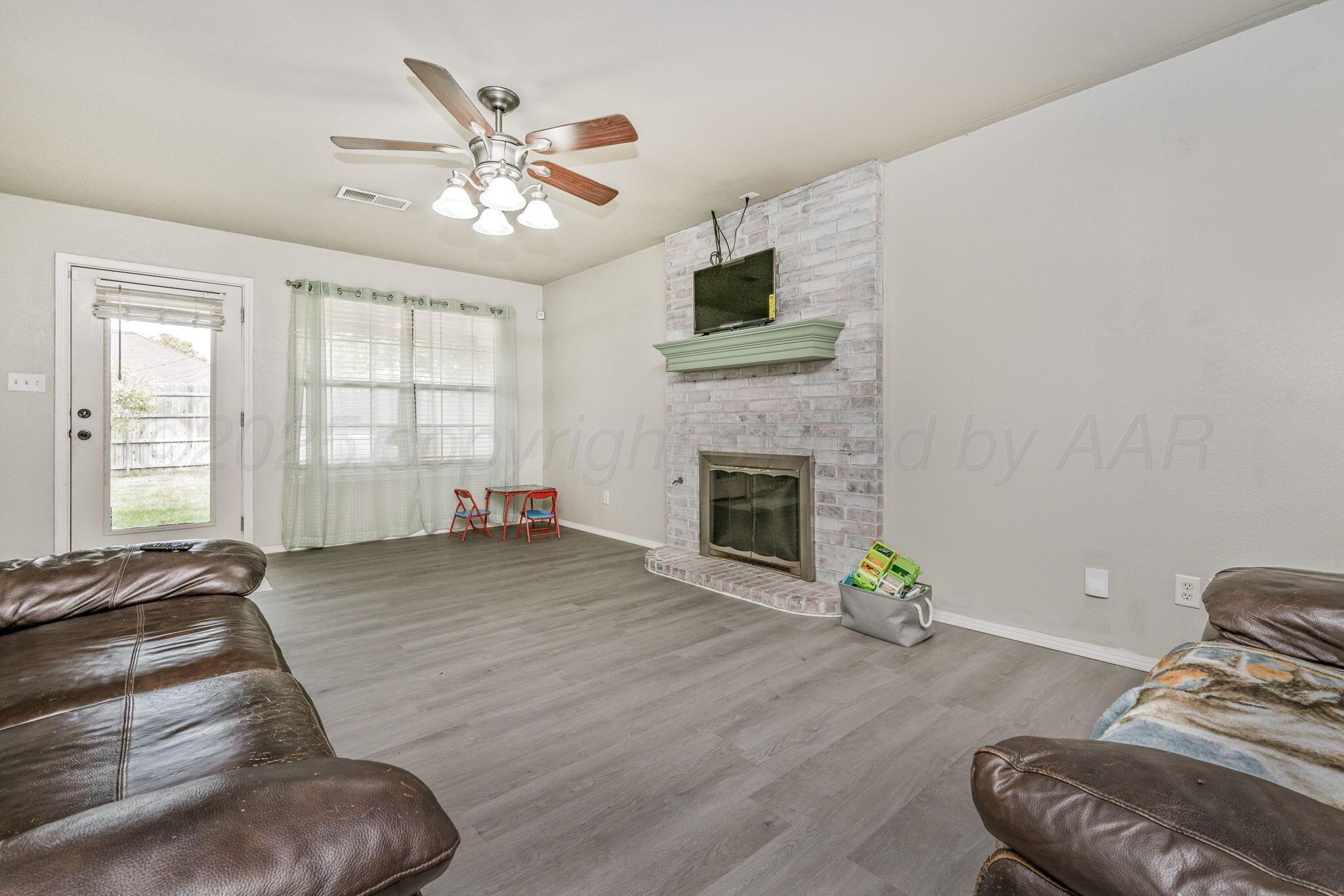 2002 Southwest 61st Avenue Amarillo, TX 79118 - Photo 4 of 21 a living room with furniture and a fireplace