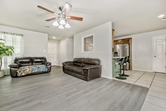 a living room with furniture and a gym machine
