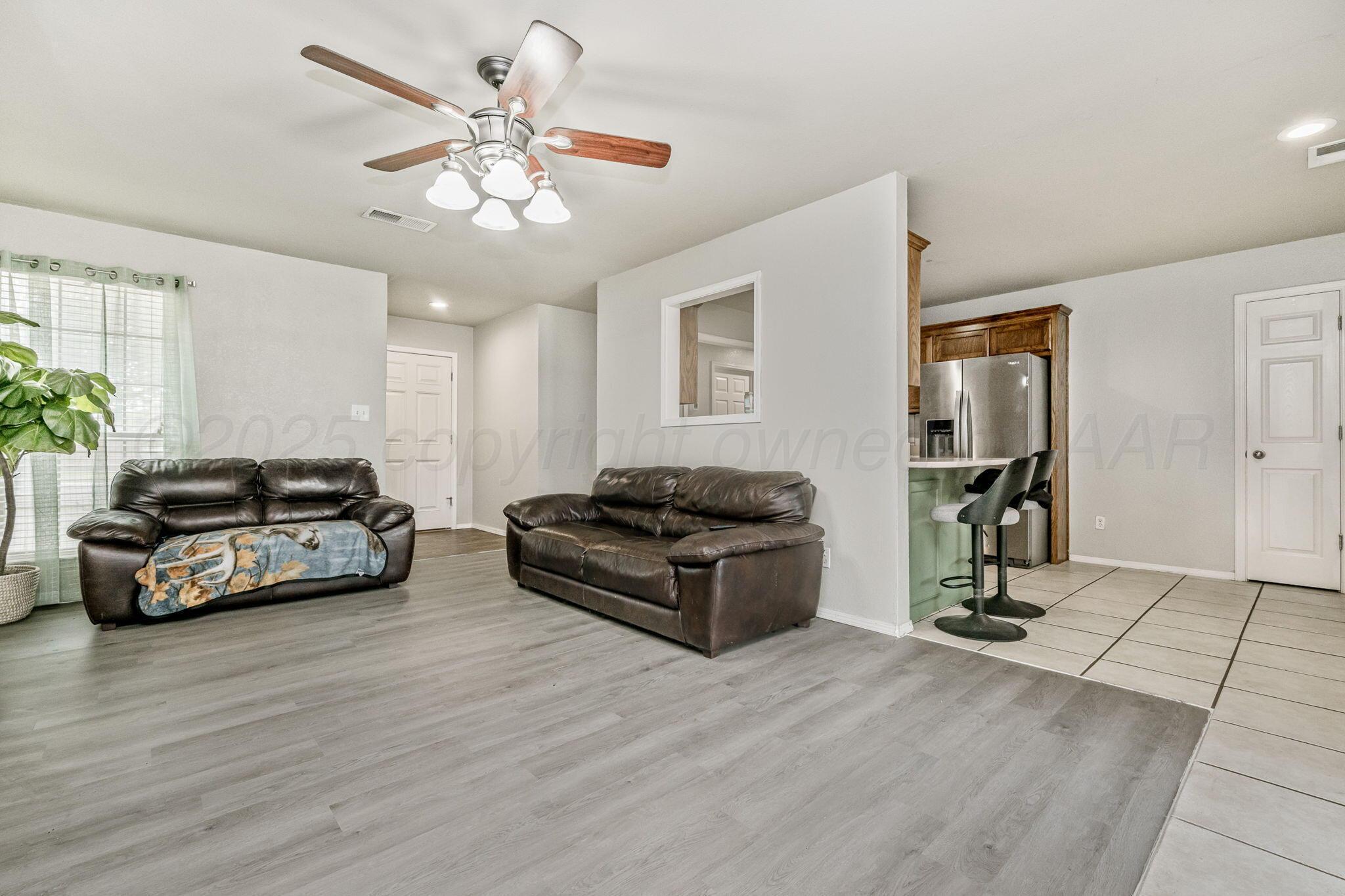 2002 Southwest 61st Avenue Amarillo, TX 79118 - Photo 5 of 21 a living room with furniture and a gym machine
