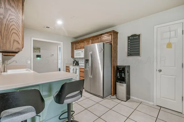 a room with furniture and a refrigerator