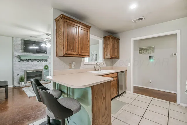 a kitchen with a sink cabinets and dining table