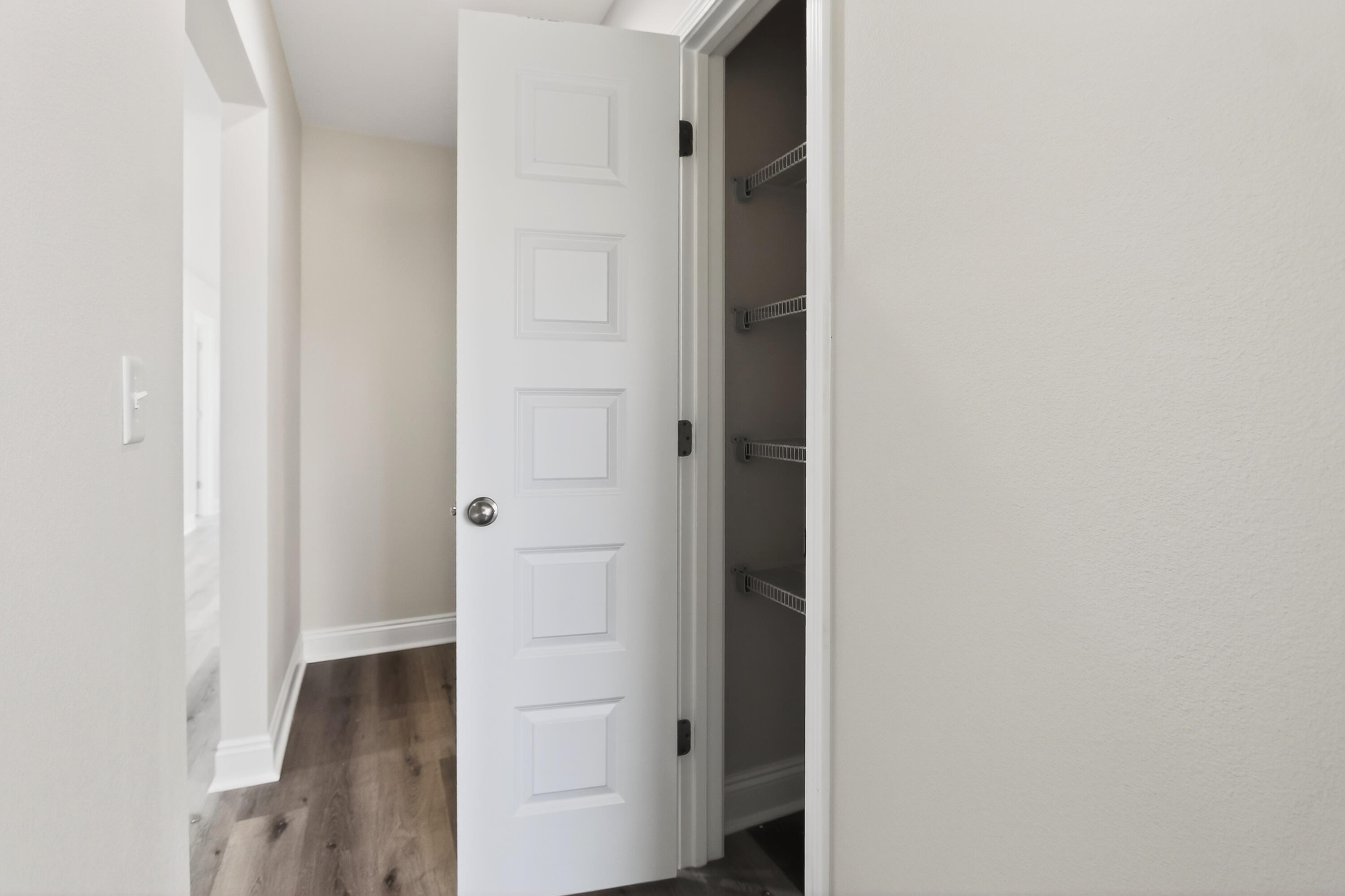5358 Highview Drive Crestview, FL 32539 - Photo 12 of 31 a view of a hallway with wooden floor